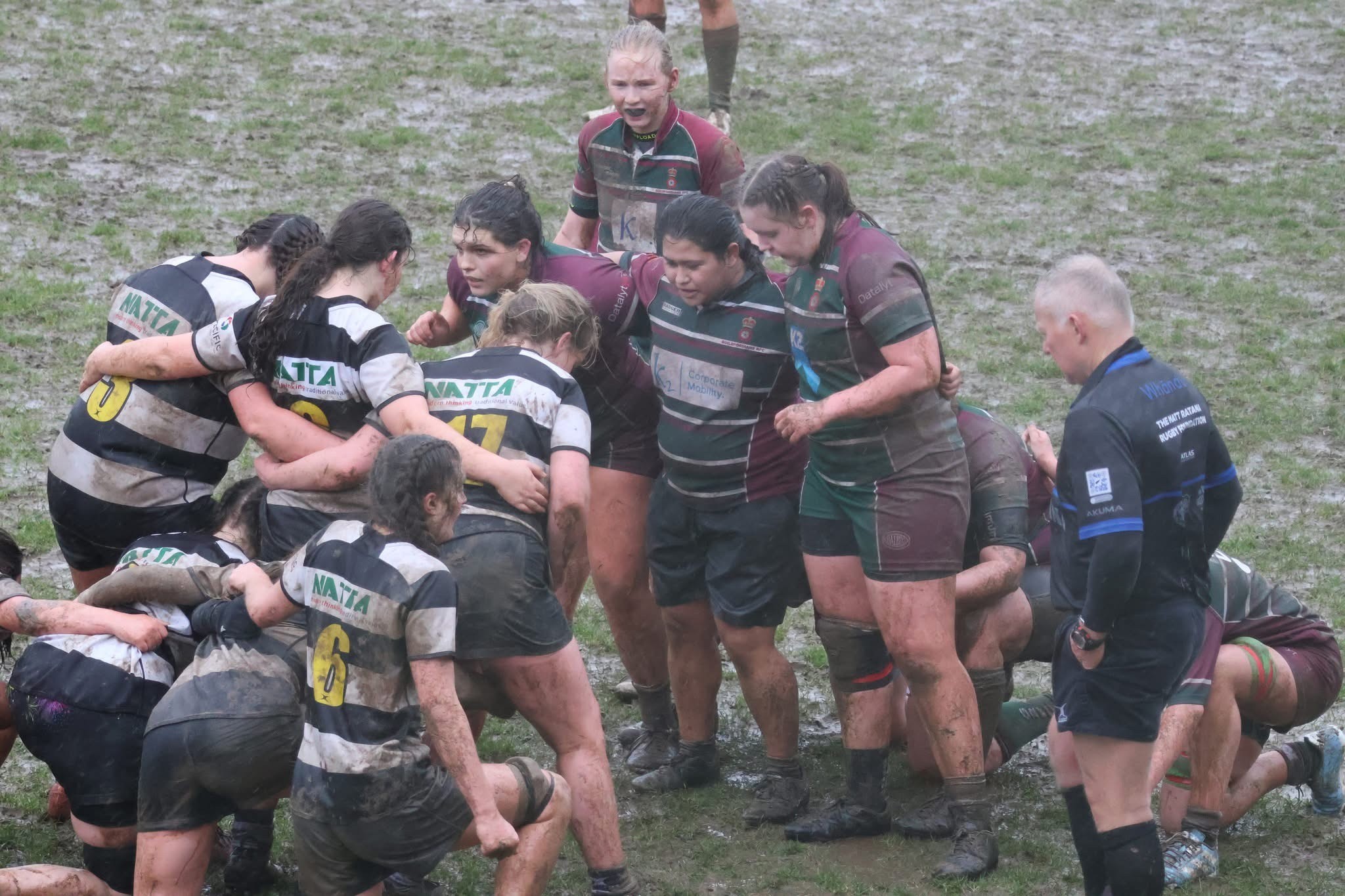 U18 Girls scrum down in muddy conditions.